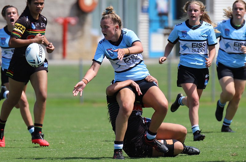 Sharks Taylah Vella unloads while being tackled in Tarsha Gale Cup game at Shark Park v the Panthers in Round 4 (Photo : Steve Montgomery)