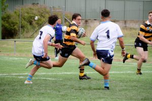 Mitch Hemderson in full flight for the Tigers against the Titans last Saturday. He looms as a major threat against Newcastle Knights on Saturday.