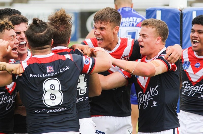 Sydney Roosters players get around Brent Hawkins after he scored the winning try
