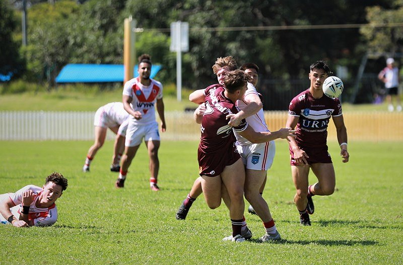 Jamie Humphreys pops a superb pass to send Kaeo Weekes over for a try (Photo : Wayne Cousins Manly Media)