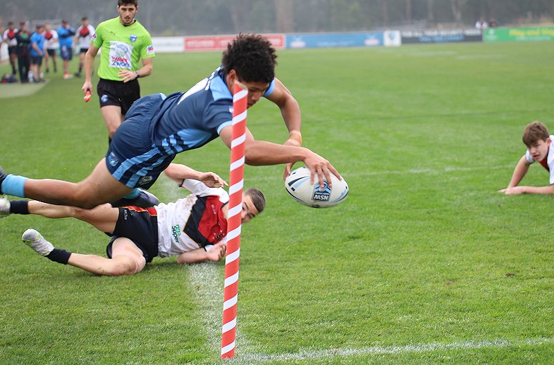 Luke Laulilii of NSWCHS Under 15's dives in for a spectacular try in today's Day 2 of the NSW Schoolboys Championships (Photo : Steve Montgomery)