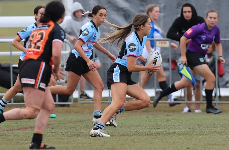 Sharks Lisa Fiaola Cup Five-eight Olivia Herman runs through the Weststigers defence during yesterday's Gala Day at Tuggerah (Photo : Steve Montgomery)
