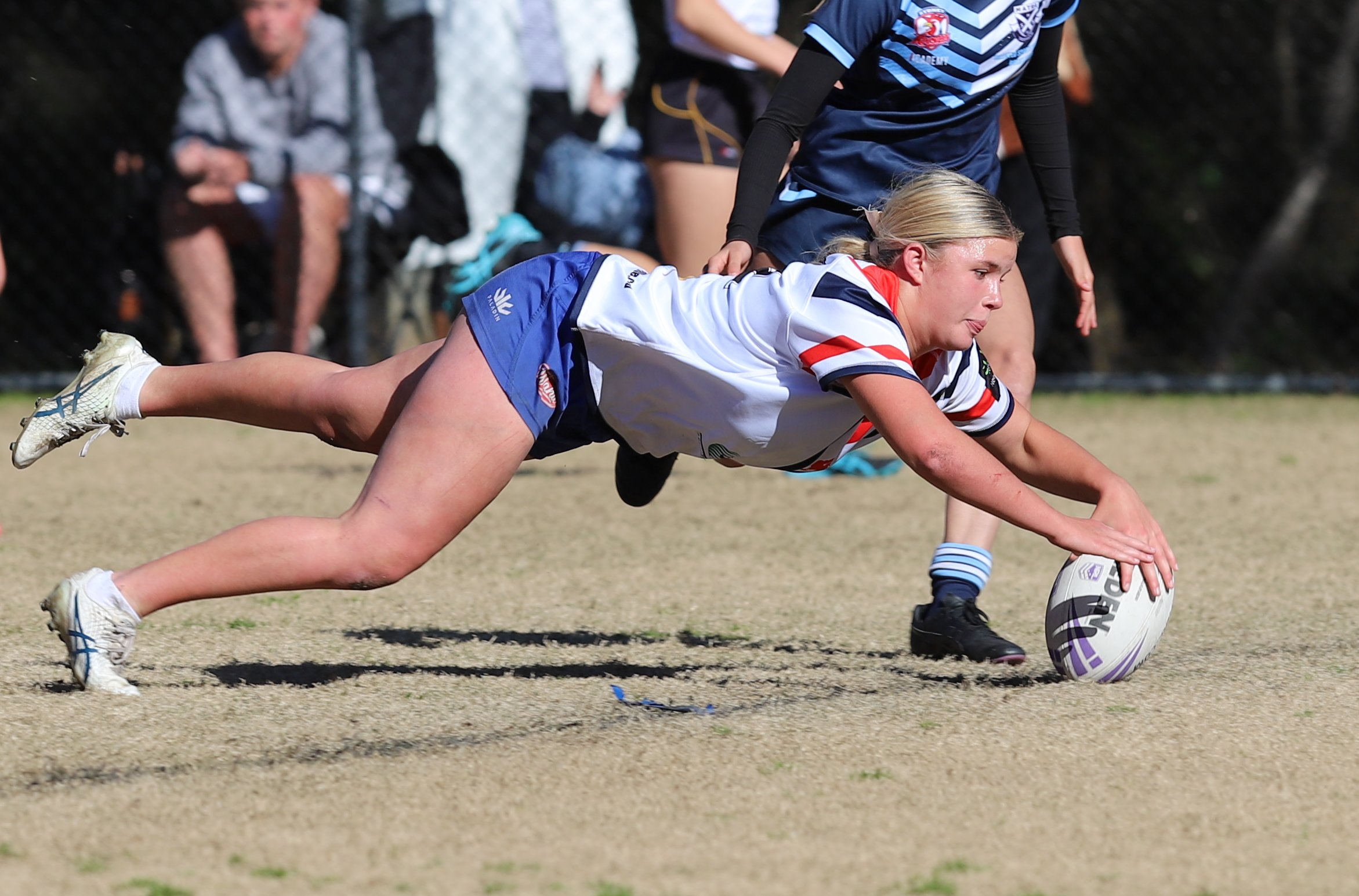 Lacey Cross dives in for one of her 2 tries of the NSWCHS Sydney Red / Gold u16 schoolgirls trails (Photo : Steve Montgomery)