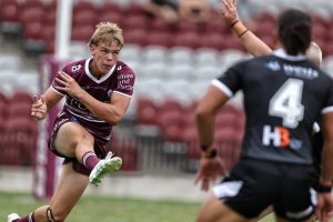 Big boot….Manly five-eighth Charlie Boyle kicks downfield David MacLean (PBS Sportspics)